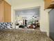This lovely kitchen offers granite counters with a pass-through to the living and dining rooms at 6110 Country Club Way # 102, Sarasota, FL 34243