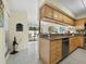 Well-appointed kitchen features granite counters, wooden cabinets, and open access to the lanai at 6110 Country Club Way # 102, Sarasota, FL 34243