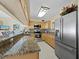 Well-equipped kitchen features granite counters, modern appliances, and ample cabinet space at 6110 Country Club Way # 102, Sarasota, FL 34243