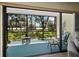 Enjoy the spacious lanai with screened enclosure and views of the lush backyard at 6110 Country Club Way # 102, Sarasota, FL 34243