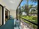 Spacious lanai features an extended, screened enclosure overlooking the landscaped backyard at 6110 Country Club Way # 102, Sarasota, FL 34243