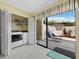 Laundry area with washer, dryer, closet, and slider to the private patio at 6110 Country Club Way # 102, Sarasota, FL 34243