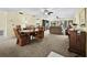 A spacious living room with comfortable furniture and a dining area with a round table and four chairs at 6110 Country Club Way # 102, Sarasota, FL 34243
