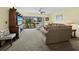 Relaxing living room features a large window with views of the outdoor landscape and comfortable seating at 6110 Country Club Way # 102, Sarasota, FL 34243