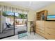 Sliding glass door leading to the private patio with lounge chairs and landscaping at 6110 Country Club Way # 102, Sarasota, FL 34243