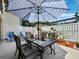 Outdoor dining on the patio with a white fence and landscaping at 6110 Country Club Way # 102, Sarasota, FL 34243