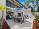 Private patio features an outdoor dining area, lounge chairs, grill, and manicured landscaping at 6110 Country Club Way # 102, Sarasota, FL 34243