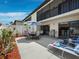 Private patio includes a dining area, grill, lounge chairs, and access to Primary bedroom at 6110 Country Club Way # 102, Sarasota, FL 34243