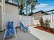 Private patio featuring white fencing, lounge chairs, landscaping, and pavers at 6110 Country Club Way # 102, Sarasota, FL 34243