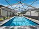 A screened-in pool with an outdoor lounge and clear blue water offers the perfect blend of relaxation and sun-soaked enjoyment at 6110 Country Club Way # 102, Sarasota, FL 34243