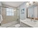 Bright bathroom featuring a shower-tub combo and stylish finishes at 6150 Midnight Pass Rd # V4, Sarasota, FL 34242
