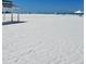 Spacious white sand beach with a lifeguard station and clear skies above at 6150 Midnight Pass Rd # V4, Sarasota, FL 34242