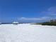 Beautiful beach with a bright blue sky and white sand, perfect for a relaxing day at 6150 Midnight Pass Rd # V4, Sarasota, FL 34242