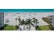 Stunning beach view with palm trees, white sand, and clear turquoise ocean at 6150 Midnight Pass Rd # V4, Sarasota, FL 34242