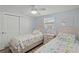 Cozy bedroom featuring twin beds, light blue walls, and a closet at 6150 Midnight Pass Rd # V4, Sarasota, FL 34242