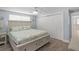Comfortable bedroom featuring a large bed with drawers for extra storage at 6150 Midnight Pass Rd # V4, Sarasota, FL 34242