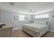 Calming bedroom with a large bed with drawers, fan, and light blue walls at 6150 Midnight Pass Rd # V4, Sarasota, FL 34242