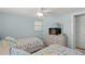 Cozy bedroom featuring twin beds, a dresser, and a ceiling fan at 6150 Midnight Pass Rd # V4, Sarasota, FL 34242