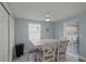 The dining area features a ceiling fan, seating for four and easy access to the patio at 6150 Midnight Pass Rd # V4, Sarasota, FL 34242