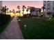 Sunset lights up walkway lined with palm trees, a lovely landscaped view at 6150 Midnight Pass Rd # V4, Sarasota, FL 34242