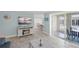 Open-concept living room featuring tile flooring, dining area, and a glimpse of the patio at 6150 Midnight Pass Rd # V4, Sarasota, FL 34242