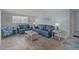 Inviting living area with two comfortable sofas, beach-themed decorations, and ample natural light at 6150 Midnight Pass Rd # V4, Sarasota, FL 34242