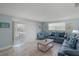 Bright living room features tile floors, comfortable couches, and plenty of natural light at 6150 Midnight Pass Rd # V4, Sarasota, FL 34242