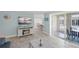Inviting living room has tile floors and sliding doors leading to the outside at 6150 Midnight Pass Rd # V4, Sarasota, FL 34242