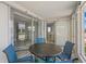 Enclosed patio offers outdoor dining, adjacent to indoor living and dining spaces at 6150 Midnight Pass Rd # V4, Sarasota, FL 34242