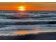 Beautiful beach sunset casting golden light on the ocean waves, creating a tranquil scene at 6150 Midnight Pass Rd # V4, Sarasota, FL 34242