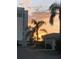 Stunning sunset view with palm trees silhouetted against colorful skies behind condos at 6150 Midnight Pass Rd # V4, Sarasota, FL 34242
