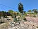 Back yard with pavers featuring garden beds and established greenery at 616 63Rd W Ave, Bradenton, FL 34207