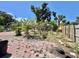 Landscaped back yard featuring established trees and plants, with brick pavers and wood fence at 616 63Rd W Ave, Bradenton, FL 34207