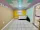 Bedroom featuring a ceiling tile design, tile floors and yellow paint at 616 63Rd W Ave, Bradenton, FL 34207