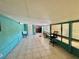 Spacious bonus room with tile flooring, utility sink and access to both the interior and exterior of the property at 616 63Rd W Ave, Bradenton, FL 34207