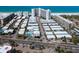 Aerial view of community with a pool, nearby buildings, and beautiful beach at 6300 Midnight Pass Rd # 5, Sarasota, FL 34242