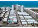 Aerial view of condo community near the beach, featuring white rooftops and a refreshing pool area at 6300 Midnight Pass Rd # 5, Sarasota, FL 34242