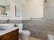 Stylish bathroom featuring a modern vessel sink, wood cabinetry, and tiled shower at 6300 Midnight Pass Rd # 5, Sarasota, FL 34242