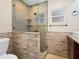 Bathroom showcasing tiled shower with glass door and shower head, and tiled walls at 6300 Midnight Pass Rd # 5, Sarasota, FL 34242