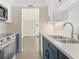 Modern kitchen showcasing stainless steel appliances, bright white cabinets, and sleek countertops at 6300 Midnight Pass Rd # 5, Sarasota, FL 34242