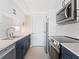 Updated kitchen featuring white cabinets, stainless steel appliances, and modern fixtures at 6300 Midnight Pass Rd # 5, Sarasota, FL 34242