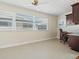 Bright office area with tile flooring, neutral walls, built-in shelving, and a large window at 6300 Midnight Pass Rd # 5, Sarasota, FL 34242
