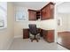 Home office featuring custom desk, granite counters, hardwood chair, and natural light at 6300 Midnight Pass Rd # 5, Sarasota, FL 34242