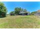 View of the back exterior of the home with a large yard at 6332 7Th E Ct, Bradenton, FL 34203