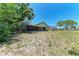 Spacious backyard showing mature landscaping, a screened patio and fencing at 6332 7Th E Ct, Bradenton, FL 34203