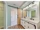 Beautiful bathroom featuring a double vanity, a sliding barn door, and a modern design at 6332 7Th E Ct, Bradenton, FL 34203