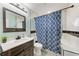 The bathroom showcases a modern vanity, mirror, and stylish tile work throughout at 6332 7Th E Ct, Bradenton, FL 34203