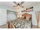 Relaxing bedroom featuring stylish décor, a ceiling fan, and hardwood floors at 6332 7Th E Ct, Bradenton, FL 34203