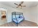 Bedroom includes a bunk bed, a ceiling fan, and wood-look flooring at 6332 7Th E Ct, Bradenton, FL 34203