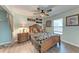 Cozy bedroom featuring a ceiling fan, a wooden bed frame and beautiful decorative artwork at 6332 7Th E Ct, Bradenton, FL 34203